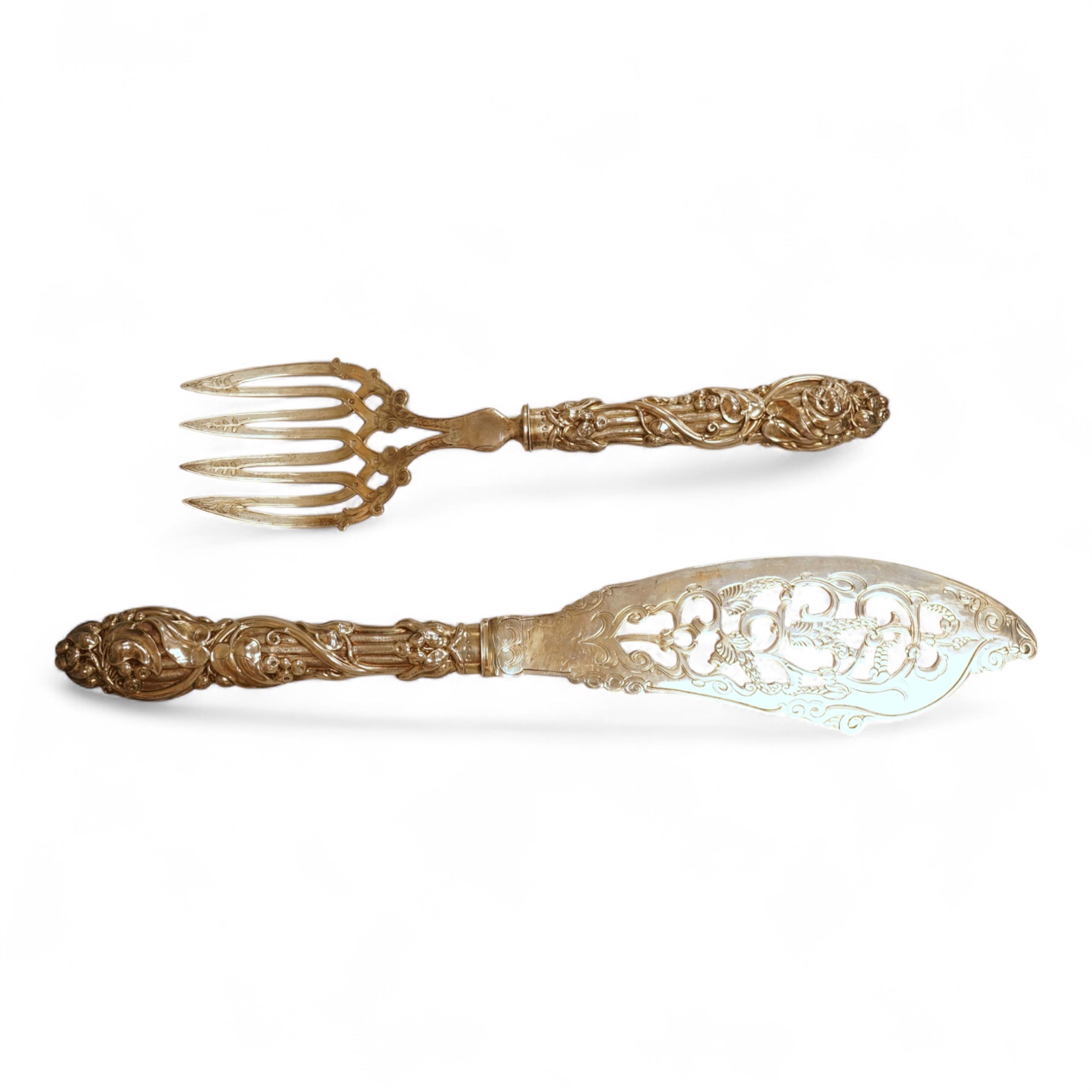 A pair of Victorian ornate silver fish servers, by John Gilbert, Birmingham, 1864, 34.1cm.